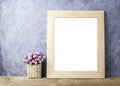 Pink paper rose flowers in basket and blank picture frame Royalty Free Stock Photo