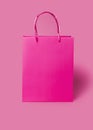 Pink paper shopping bag on pink background. Shopping sale delivery concept. Packaging gift