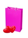 Pink paper shopping bag and two red heart isolated on white Royalty Free Stock Photo