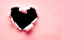 Pink paper teared in heart shape with black space Royalty Free Stock Photo