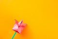 Pink paper tulip on orange background