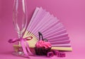 Pink party decorations with fan, champagne glass and high heel shoe cupcake Royalty Free Stock Photo