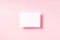 Pink pastel background with blank white postcard.