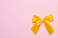 Pink pastel background and yellow gift satin ribbon bow copyspace Royalty Free Stock Photo