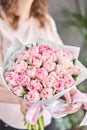 Pink pastel color tulips in woman hand. Young beautiful woman holding a spring bouquet. Bunch of fresh cut spring