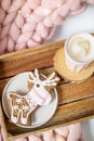 Pink pastel merino woolen giant blanket, gingerbread deer, cup with cappuccino