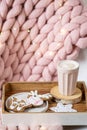Pink pastel merino woolen giant blanket, gingerbread deer, cup with cappuccino