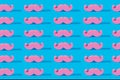 Pink pastel mustache pattern and on a blue background. A symbol of father day.