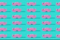 Pink pastel mustache pattern on a mint green background.