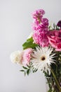 Pink and pastel white flowers in Modern glass vase on gray wall background Royalty Free Stock Photo