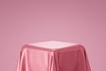 Pink pedestal or podium display with satin fabric platform concept on valentines background. Blank shelf stand for showing product