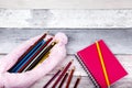 Pink pencil case and notepad laying on peeling painted floor Royalty Free Stock Photo