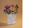 Pink peonies in an abstract porcelain vase stylized as a bag. Free space.