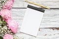 Pink Peonies and Babys Breath Flowers with Note Pad over a White Wood Background Royalty Free Stock Photo