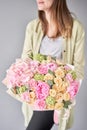 Pink peonies and hydrangea. Beautiful bouquet of mixed flowers in woman hand. Floral shop concept . Handsome fresh