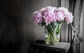 Pink peonies in vase on rustic wooden table. Romantic home decoration. Royalty Free Stock Photo