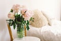 Pink Peonys bouquet on a white chair in the living room.