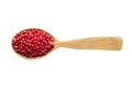 Pink peppercorn in wooden spoon isolated on white background. spice for cooking food, top view Royalty Free Stock Photo