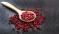 Pink peppercorn with a low-light wooden spoon Placed on a gray background with a rough floor Royalty Free Stock Photo