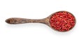 Pink peppercorn in wood spoon on white background. top view Royalty Free Stock Photo