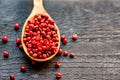 Pink peppercorn in wooden spoon studio shot Royalty Free Stock Photo