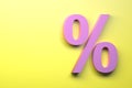 Pink percent sign on the yellow background.