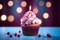 Pink perfection Birthday cupcake with burning candle on blue background Royalty Free Stock Photo