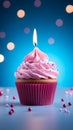 Pink perfection Birthday cupcake with burning candle on blue background Royalty Free Stock Photo