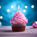 Pink perfection Birthday cupcake with burning candle on blue background Royalty Free Stock Photo