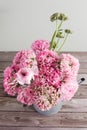 Pink persian buttercup flowers. Curly peony ranunculus in Metallic gray vintage watering can, copy space. Royalty Free Stock Photo