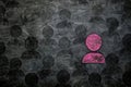 A pink person stands boldly against a stark black background, contrasting vividly in a dramatic display of color and