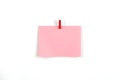A pink piece of paper with a red clip hanging from it Royalty Free Stock Photo