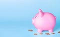 Piggy bank and coins money on blue background. Finance saving concept Royalty Free Stock Photo