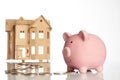 Pink piggy bank, coins trail and a house Royalty Free Stock Photo