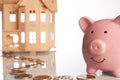 Pink piggy bank, coins trail and a house Royalty Free Stock Photo