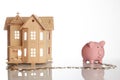 Pink piggy bank, coins trail and a house Royalty Free Stock Photo