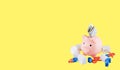 Pink piggy bank, dollar, houses and percent isolated against yellow background How to get a mortgage. Royalty Free Stock Photo