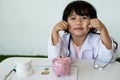 Pink piggy bank with Kid doctor and Medical equipment, Saving money for future plan and Health insurance concept