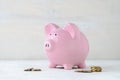 Pink piggy bank with loose cash coins Royalty Free Stock Photo