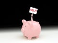 Pink piggy bank with man inside holding up HELP! sign Royalty Free Stock Photo