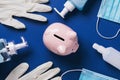 Pink piggy bank and medical supplies on a blue background, top view Royalty Free Stock Photo
