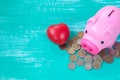 Pink piggy bank over coins stack, saving money Royalty Free Stock Photo
