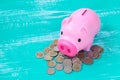 pink piggy bank over coins stack, saving money Royalty Free Stock Photo