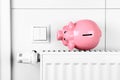 Pink piggy bank saving heating and electricity costs Royalty Free Stock Photo