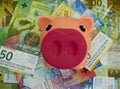 Pink piggy bank with swiss money and currency of switzerland. Swiss francs. Money Royalty Free Stock Photo