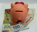 Pink piggy bank with swiss money and currency of switzerland. Swiss francs. Money in Switzerland Royalty Free Stock Photo