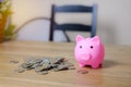 Pink Piggy bank and Thai coins stacks on the wooden table. Saving money for future investments and for emergency case concept Royalty Free Stock Photo