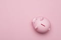 Pink piggybank seen from a high anlge view on a pink background as concept for financial issues Royalty Free Stock Photo