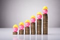 Pink Piggybank With Yellow Hardhat On Increasing Stacked Coins