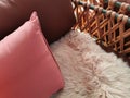 Pink pillows and a white lambskin